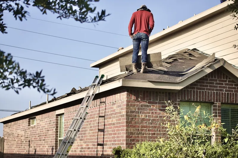 Professional roofer working on a residential roof in Pleasant Grove